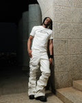 White Oversabi Extra Long Pants by OVERSABI HIGHSCHOOL, shown with a focus on the long, slim-fit design and fabric texture.