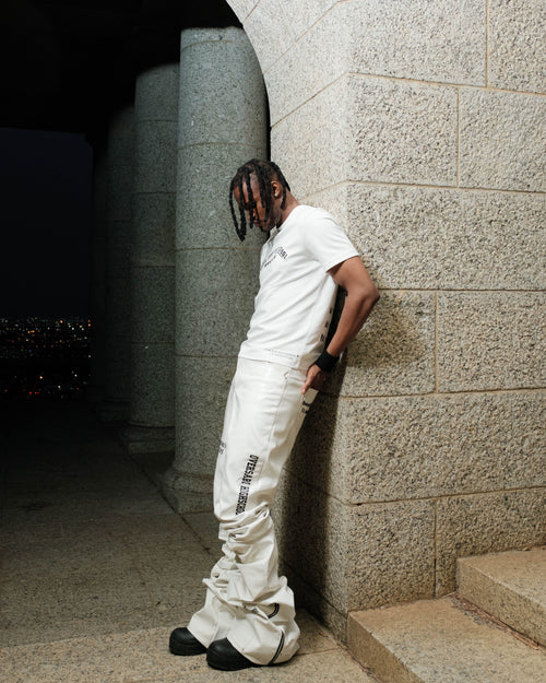 White Oversabi Extra Long Pants by OVERSABI HIGHSCHOOL, showing the full length, slim fit design, and fabric details.